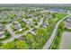Community aerial view with well-manicured green spaces, a pond, and an abundance of housing at 5737 Arlington Dr, Plainfield, IN 46168