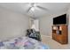 Bedroom featuring a fan, TV and quilt-covered bed at 5737 Arlington Dr, Plainfield, IN 46168