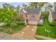 Beautifully landscaped two-story brick home with mature tree and two car garage at 5737 Arlington Dr, Plainfield, IN 46168