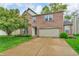 Charming two-story brick home with a well-maintained lawn and a two-car garage at 5737 Arlington Dr, Plainfield, IN 46168