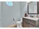 Stylish half bathroom featuring modern fixtures, decorative mirror, and neutral tones at 5737 Arlington Dr, Plainfield, IN 46168