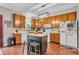 Functional kitchen featuring an island, wood cabinets, and appliances at 5737 Arlington Dr, Plainfield, IN 46168