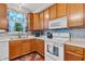 Well-lit kitchen with wood cabinets, modern appliances, and tiled backsplash at 5737 Arlington Dr, Plainfield, IN 46168