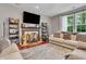 Bright living room featuring a decorative fireplace and a cozy seating area with view of the backyard at 5737 Arlington Dr, Plainfield, IN 46168