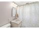 Clean bathroom with white vanity, mirror, and shower with patterned curtain at 5889 W Homestead Dr, Frankton, IN 46044