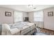 Cozy bedroom with comfortable bed, patterned quilt, and bright, airy windows at 5889 W Homestead Dr, Frankton, IN 46044