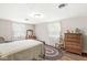 Bright bedroom with two windows, wood floors, and classic furnishings for a cozy feel at 5889 W Homestead Dr, Frankton, IN 46044