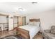 Inviting bedroom with hardwood floors, dual closets, and cozy armchair at 5889 W Homestead Dr, Frankton, IN 46044