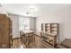 Bright dining room with a wooden table set and a window with lace curtains at 5889 W Homestead Dr, Frankton, IN 46044