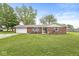 Charming brick home with attached garage and well-maintained lawn and landscaping at 5889 W Homestead Dr, Frankton, IN 46044
