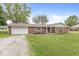 Attractive brick home with well-manicured lawn, a garage, and a welcoming facade at 5889 W Homestead Dr, Frankton, IN 46044