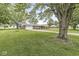 Charming brick home boasts a spacious front yard with mature trees and inviting curb appeal at 5889 W Homestead Dr, Frankton, IN 46044