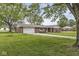 Brick home with a large front yard, long driveway, attached garage, and mature trees at 5889 W Homestead Dr, Frankton, IN 46044