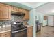 Updated kitchen with mosaic tile backsplash, sleek appliances, and natural wood cabinetry at 5889 W Homestead Dr, Frankton, IN 46044
