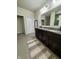 Bathroom features a double vanity with granite countertops, tile floors, and a door to the WC at 589 Viking Warrior Blvd, Westfield, IN 46074