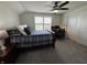 Comfortable bedroom featuring a work desk with a modern ceiling fan and plush carpet, perfect for relaxation at 589 Viking Warrior Blvd, Westfield, IN 46074