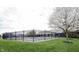 Fenced community pool surrounded by green lawn and a flowering tree, offering a refreshing outdoor amenity at 589 Viking Warrior Blvd, Westfield, IN 46074
