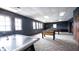 Well-lit game room with air hockey table, foosball, and pool table, featuring dark blue walls and patterned carpet at 589 Viking Warrior Blvd, Westfield, IN 46074