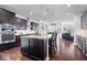 Open-concept kitchen with a center island, stainless steel appliances, and views into the living area at 589 Viking Warrior Blvd, Westfield, IN 46074