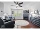 Inviting living room featuring dark wood floors, a fireplace, and stylish furniture with a ceiling fan at 589 Viking Warrior Blvd, Westfield, IN 46074