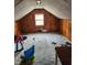Attic space featuring wood paneled walls and a window for natural light at 621 E 31St St, Anderson, IN 46016