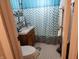 Cozy bathroom features a patterned blue shower curtain, a sink vanity and hexagon tile floor at 621 E 31St St, Anderson, IN 46016