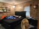 Bedroom with a dark bed frame and neutral-toned walls at 621 E 31St St, Anderson, IN 46016