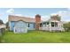 Backyard view of a blue house, brick chimney, back porch and shed at 6627 Cobden Ct, Indianapolis, IN 46254