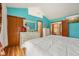 Bright bedroom with wooden floors, large dresser, and bed with white comforter at 6627 Cobden Ct, Indianapolis, IN 46254