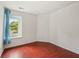 Bright, vacant bedroom with wood floors and a large window at 6627 Cobden Ct, Indianapolis, IN 46254