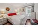 Bedroom featuring wood floors, bedside tables with lamps, and a window with curtains at 6627 Cobden Ct, Indianapolis, IN 46254