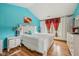 Bright bedroom featuring a large bed, bedside tables, and a decorative window treatment at 6627 Cobden Ct, Indianapolis, IN 46254