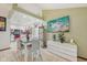 Open-concept dining area with tile flooring, modern furnishings, and views into the kitchen and living room at 6627 Cobden Ct, Indianapolis, IN 46254