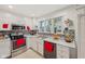Bright kitchen with white cabinetry, stainless steel appliances, tile backsplash, and modern fixtures at 6627 Cobden Ct, Indianapolis, IN 46254