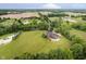 Expansive aerial shot capturing a home surrounded by lush greenery and open fields, offering a serene and private setting at 6630 Travis Rd, Greenwood, IN 46143