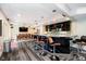 Basement featuring a dining area, a bar area, wood floors, and entertainment space for gatherings at 6630 Travis Rd, Greenwood, IN 46143