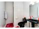 Elegant powder room featuring a black pedestal sink and toilet against tiled walls at 6630 Travis Rd, Greenwood, IN 46143