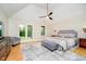 Serene bedroom with vaulted ceiling, hardwood floors, and a cozy seating area at 6630 Travis Rd, Greenwood, IN 46143