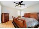 Bedroom with wood floors, a window providing natural light, and a dresser with traditional charm at 6630 Travis Rd, Greenwood, IN 46143