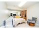 Bright bedroom with full mirrored wall, two beds, rocker, and closet at 6630 Travis Rd, Greenwood, IN 46143