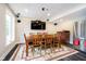 A dining room features a wood table, stainless steel refrigerator, and wall mounted television at 6630 Travis Rd, Greenwood, IN 46143