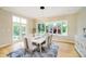 Bright dining room with contemporary lighting, large windows, and access to the backyard at 6630 Travis Rd, Greenwood, IN 46143
