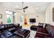 Cozy living room with dark leather sectional, ceiling fan and decorative shelving at 6630 Travis Rd, Greenwood, IN 46143