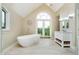 Bright bathroom with a freestanding tub, walk-out to balcony, and a elegant vanity at 6630 Travis Rd, Greenwood, IN 46143