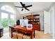 Bright home office featuring french doors, vaulted ceilings, and built-in shelving for storage at 6630 Travis Rd, Greenwood, IN 46143