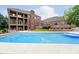 A luxurious backyard featuring a private pool and brick home with balconies and a patio perfect for outdoor entertaining at 6630 Travis Rd, Greenwood, IN 46143