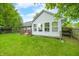 Inviting backyard with a wooden deck and mature trees, perfect for outdoor relaxation at 6737 Raritan Dr, Indianapolis, IN 46221