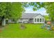 Picturesque backyard with a patio, playhouse, and well-manicured lawn at 6737 Raritan Dr, Indianapolis, IN 46221