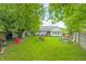 Large backyard featuring a shed, play area, and mature trees at 6737 Raritan Dr, Indianapolis, IN 46221