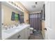 Bathroom featuring a double sink vanity, modern fixtures, and a shower with curtain at 6737 Raritan Dr, Indianapolis, IN 46221